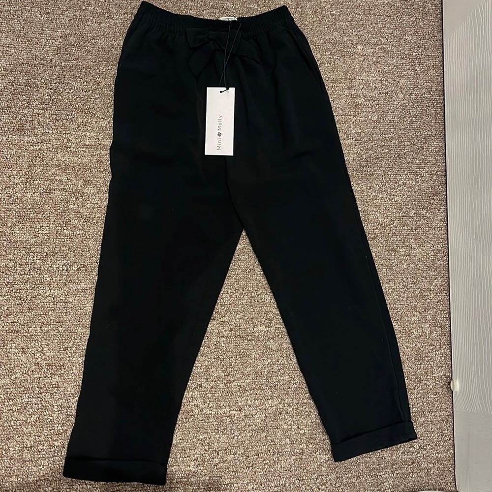 Mini Molly black dress pant. Size 4-6. With tags. Never been worn. Extra button.